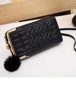 Close-up of V-quilted black leather phone wallet with gold metal clip and tassel