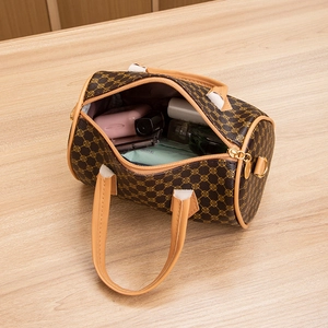 Brown printed boston bag with yellow handles showing spacious inner storage space