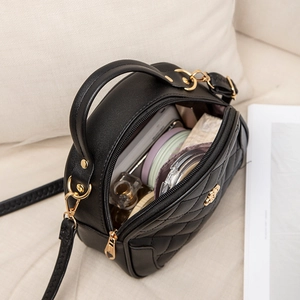 Black quilted crossbody bag with gold hardware showing large interior capacity for cosmetics