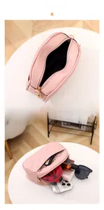 Detail showing internal capacity of pink quilted crossbody bag with phone and essentials