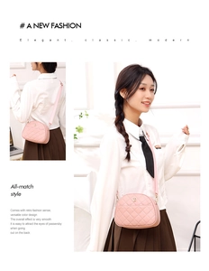Pink quilted crossbody bag detail with metallic floral logo and adjustable strap