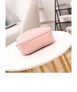 Detailed bottom view of pink quilted chain bag with elegant rhombus stitching and gold hardware