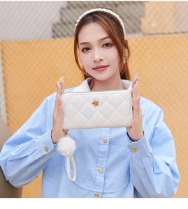 Close-up of pearl white long wallet with quilted pattern and golden rose ornament