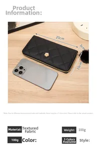 Size comparison of a black quilted long wallet with a phone and a plush pompom charm