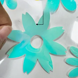 Close-up of teal cherry blossom glow stickers held in hand for home staircase decor