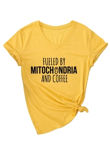 Detail of yellow V-neck T-shirt showing Fueled by Mitochondria and Coffee black print