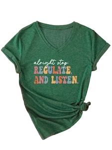 Detail of heather green V-neck T-shirt featuring a side knot hem and retro slogan print