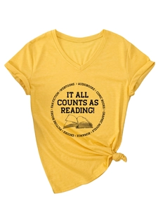 Detail of V-neck yellow tee with 'IT ALL COUNTS AS READING' print and knotted hem