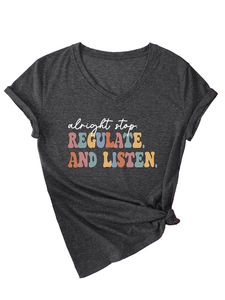 Detail of V-neck dark grey t-shirt featuring 'alright stop' text and front knot design