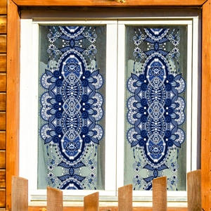 Blue and white mandala window film stickers with elegant baroque patterns on a glass window