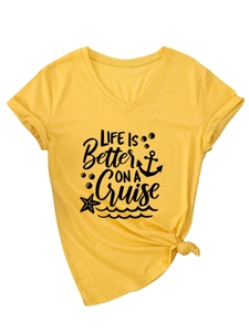 Detail of yellow V-neck T-shirt with 'Life is better on a cruise' text and hem knot