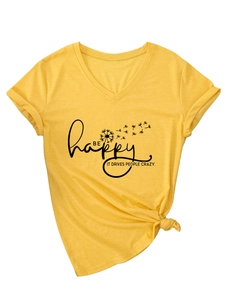 Detail of yellow V-neck tee with rolled sleeves, knot hem, and Be Happy slogan
