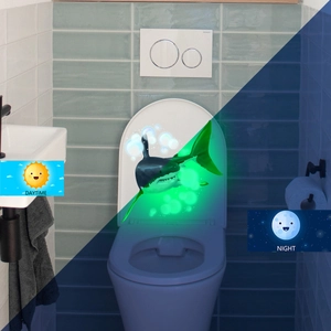 Glow-in-the-dark shark toilet decal showing day and night fluorescent visual effect