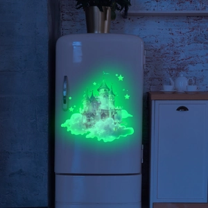 Luminous wall sticker showing a pink dream castle and stars glowing on a white fridge door