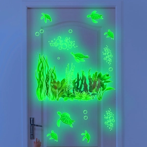 Luminous marine life wall decals featuring glowing turtles and seaweed on a wooden door