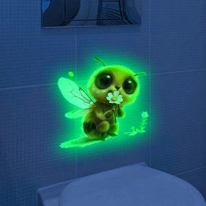 Luminous cartoon bee wall sticker glowing in green on dark bathroom tile wall