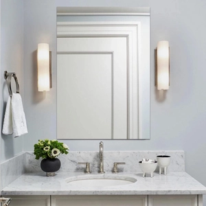 Pair of modern silver wall sconces with frosted glass shades in a bathroom setting