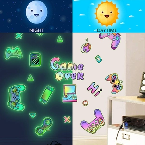 Luminous gaming wall sticker set featuring gamepads and icons for day and night decor