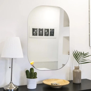Modern frameless oval wall mirror with polished edges for bedroom and living room decor