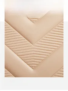 Detailed view of the apricot quilted leather texture and adjustable shoulder strap buckle