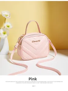 Detailed view of pink quilted handbag with gold hardware and logo on yellow background