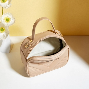 Beige quilted leather small square handbag with elegant top handle and gold hardware