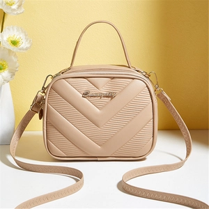 Fashionable beige crossbody bag with V-quilted texture and elegant gold logo hardware
