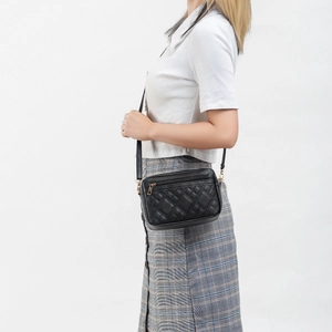 Classic black quilted crossbody bag for women with gold zipper and adjustable shoulder strap