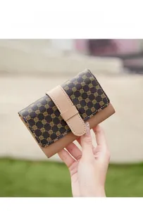 Close-up of vintage floral trifold wallet with buckle closure and leather texture