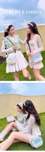 Detail showing two V-quilted gradient crossbody bags with trendy wide letter straps