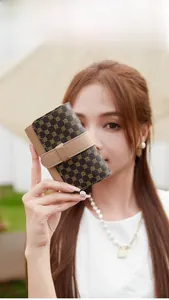 Chic women's short wallet with vintage pattern and leather patchwork held by a model