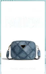 Macro detail of blue denim crossbody bag with quilted diamond pattern and triangle logo