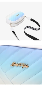 Close-up of blue-white gradient quilted crossbody bag with gold metal Lucky For You logo