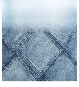 Macro detail of quilted denim fabric with diamond stitching on a blue square bag