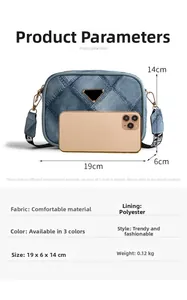Blue denim crossbody bag size comparison with a smartphone and dimension details