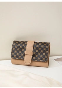 Close-up of a women's short wallet with vintage clover pattern and flap closure