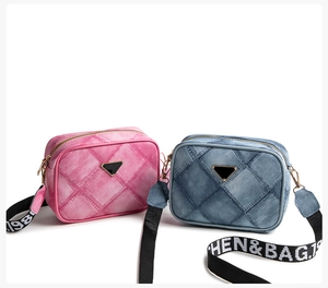 Detail of denim texture crossbody bags with quilted pattern and triangle emblem