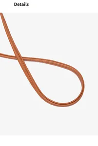 Close-up of brown leather bag strap with detailed white stitching and premium texture