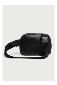 Detail of black pebbled leather texture with a durable plastic buckle on the chest bag