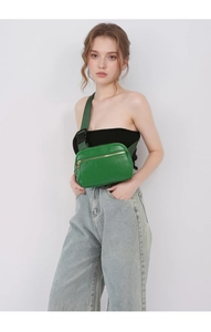 Detail of green litchi texture leather belt bag with gold zipper and adjustable strap