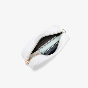 White minimalist square crossbody bag with gold zipper showing interior storage space