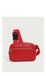 Detail of red pebbled leather waist bag with zipper pocket and adjustable strap