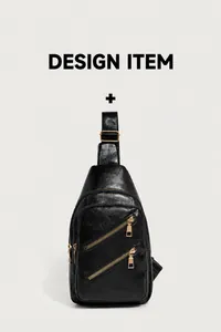 Detail view of black pebble leather crossbody bag with double gold zip front pockets