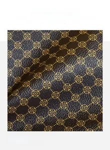 Close-up of premium brown synthetic leather with classic yellow clover pattern and texture