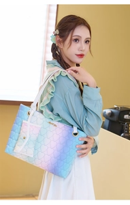 Detail of blue-purple gradient tote bag with heart quilting and mini coin purse