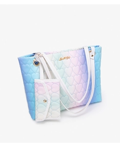 Detail view of gradient quilted tote bag set with heart embroidery and gold label