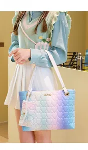 Close-up of heart-quilted gradient tote bag with matching small coin purse detail