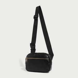 Adjustable black pebbled leather crossbody chest bag with gold zippers for women
