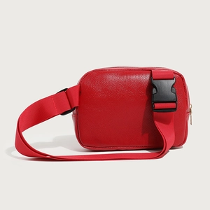 Minimalist red leather crossbody chest bag with adjustable strap and buckle closure