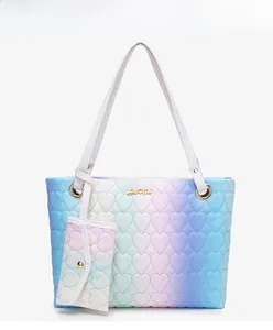 Detail of heart-quilted gradient tote bag with matching coin purse and gold hardware